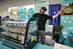 Man waving at booth